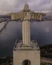 Aerial view of April 25th bridge and Cristo Rei Christ the King at sunset over the Tagus river, Almada, Lisbon, Portugal Royalty Free Stock Photo