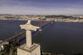 Aerial view of April 25th bridge and Cristo Rei Christ the King at sunset over the Tagus river, Almada, Lisbon, Portugal Royalty Free Stock Photo