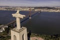 Aerial view of April 25th bridge and Cristo Rei Christ the King at sunset over the Tagus river, Almada, Lisbon, Portugal Royalty Free Stock Photo