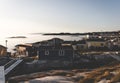 Aerial View of Arctic city of Ilulissat, Greenland during sunrise sunset with fog. Colorful houses in the center of the