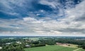 Aerial view of an area of arable land at the edge of a village with connected forest areas and trees along a road in Germany, dram Royalty Free Stock Photo