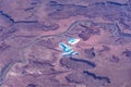 Aerial view around the Colorado River near Moab Utah in the Rocky Mountains  with Potash evaporation ponds shining bright blue Royalty Free Stock Photo