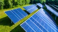 Aerial View of Array of Blue Solar Panels on Green Field Under Bright Royalty Free Stock Photo