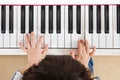 Aerial view of Asian Chinese little boy playing piano Royalty Free Stock Photo