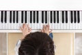 Aerial view of Asian Chinese little boy playing piano Royalty Free Stock Photo