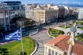 Aerial view of Athens. Greek flag and the statue of Athena in the academy of Athens