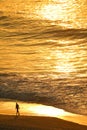 Aerial view of the Atlantic ocean in morning sunlight reflection with silhouette of a man walking on the Copacabana beach, Brazil Royalty Free Stock Photo