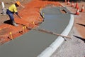 Aerial view of Australian road worker leveling a concrete sidewalk