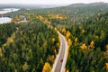 Aerial view of autumn color forest in the mountains and a road with car in Finland Lapland Royalty Free Stock Photo