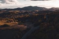 Aerial view of autumn forest with road in the middle of trees. Royalty Free Stock Photo