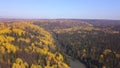 Aerial view of autumn forest and small lake. Clip. Breathtaking panoramic aerial view of the hills of colorful orange Royalty Free Stock Photo