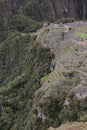 An aerial view of the back section of Machu Picchu, including farming terraces, the main temple and Intihuatana