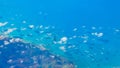 Aerial view of Bahamas shoreline under small clouds