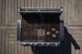 Aerial view of barbecue grill with sausages and firewood, A platter of colorful, decorated cupcakes at a birthday party, AI