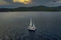 Aerial view of a bay with sailing boat at sunset Royalty Free Stock Photo