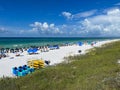 An aerial view of the Beach with Blue Umbrella and Lounge Chairs lined up at the Watercolor Community Club in Watercolor, Florida