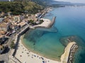 Aerial view of a beach with canoes, boats and umbrellas. Pier of Pizzo Calabro, panoramic view from above Royalty Free Stock Photo