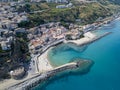 Aerial view of a beach with canoes, boats and umbrellas. Pier of Pizzo Calabro, panoramic view from above Royalty Free Stock Photo