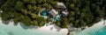 An aerial view of a beach house surrounded by palm trees. AI generative image. Royalty Free Stock Photo