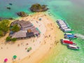 Aerial view of beach at Koh Khai, a small island, with crowd of people, tourists, blue turquoise seawater with Andaman sea in