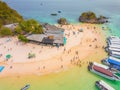 Aerial view of beach at Koh Khai, a small island, with crowd of people, tourists, blue turquoise seawater with Andaman sea in