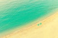 Aerial view of beach lounge with umbrellas on tropical golden paradise beach with turquoise waters