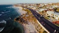 Aerial view of a beach merges with vibrant city