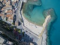 Aerial view of a beach and a pier with canoes, boats and umbrellas. Royalty Free Stock Photo