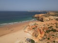 Aerial view of a beach in Portugal with a large stretch of rocks along the shore