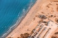 View of the beach resort infrastructure - a large filled Parking lot and many sun loungers and sunbeds by the sea