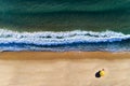 Aerial view of beach umbrella with a person sunbathing, at the Comporta Beach in Portugal.