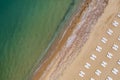 beach with white sunbeds and a calm sea Royalty Free Stock Photo