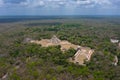 Aerial view of the beautiful Chicen Itza and Mayan Pyramid in Mexico surrounded with ground and greenery with ocean