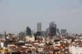 Aerial view of a beautiful cityscape of Madrid with skyscrapers against a blue cloudy sky