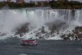 Aerial view of beautiful cruise ship with mesmerizing Niagara Falls waterfall in the background