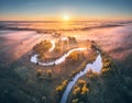 Aerial view of curving river in pink low clouds at sunrise Royalty Free Stock Photo