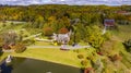 Aerial View of a Beautiful Estate, With a Pond, Gazebo and Many Buildings on an Autumn Day
