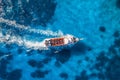 Aerial view of beautiful floating yacht in blue sea at sunny day