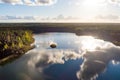 Aerial view of beautiful green waters of lake Gela. Birds eye view of scenic emerald lake surrounded by pine forests. Clouds Royalty Free Stock Photo