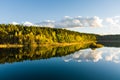 Aerial view of beautiful green waters of lake Gela. Birds eye view of scenic emerald lake surrounded by pine forests. Clouds Royalty Free Stock Photo