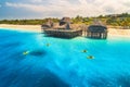 Aerial view of beautiful hotel and people in kayaks in the sea Royalty Free Stock Photo