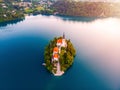 Aerial view of beautiful Lake Bled in the middle of the charming little island and the wonderful church at autumn sunrise Royalty Free Stock Photo