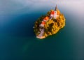 Aerial view of beautiful Lake Bled in the middle of the charming little island and the wonderful church at autumn sunrise Royalty Free Stock Photo