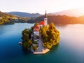 Aerial view of beautiful Lake Bled in the middle of the charming little island and the wonderful church at autumn sunrise