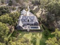 Aerial view of beautiful large home with pool on wooded lot Royalty Free Stock Photo