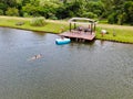 Aerial view of beautiful little wood cabana next the lake in tropical mountain,