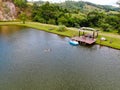 Aerial view of beautiful little wood cabana next the lake in tropical mountain,