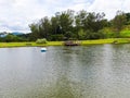 Aerial view of beautiful little wood cabana next the lake in tropical mountain,