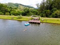 Aerial view of beautiful little wood cabana next the lake in tropical mountain,