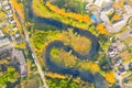 Aerial view of a beautiful meandering river. Aerial view. River bends, trees in the middle of a small town. Colorful aerial